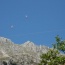 High above Le Foulon a couple of paragliders make like birds and seek out the thermals.